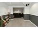 Finished basement space showcasing neutral carpet, wainscoting, and a connected seating area at 5938 Haverford Ave, Indianapolis, IN 46220