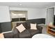 Finished basement area featuring neutral carpet, wainscoting, and a comfortable gray couch at 5938 Haverford Ave, Indianapolis, IN 46220
