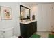 Bathroom featuring a dark vanity with a white countertop and framed mirror at 5938 Haverford Ave, Indianapolis, IN 46220