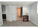Basement room with an open door leading to a full bathroom and closet space at 5938 Haverford Ave, Indianapolis, IN 46220