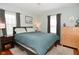 Bright bedroom with a large bed, wood floors, neutral walls, and two windows at 5938 Haverford Ave, Indianapolis, IN 46220