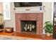 A brick fireplace with a white mantel displays decor and greenery at 5938 Haverford Ave, Indianapolis, IN 46220