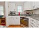 Well-lit kitchen featuring white cabinets, granite countertops, and stainless steel oven at 5938 Haverford Ave, Indianapolis, IN 46220