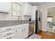 Updated kitchen with white cabinets, granite countertops, and stainless steel refrigerator at 5938 Haverford Ave, Indianapolis, IN 46220