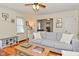 Bright living room with a gray sofa, hardwood floors, and views into the kitchen area at 5938 Haverford Ave, Indianapolis, IN 46220