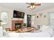 Cozy living room with brick fireplace, a flat screen TV, and a ceiling fan at 5938 Haverford Ave, Indianapolis, IN 46220