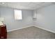 Bright, carpeted room with a window and neutral walls, suitable for a bedroom or office at 5938 Haverford Ave, Indianapolis, IN 46220