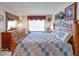 Cozy bedroom with a window, carpeted floors, and traditional furnishings including a dresser at 6146 Franklin Villas Way, Indianapolis, IN 46237