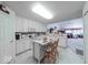 Bright kitchen features an island, white cabinets, and an open layout that flows into the living area at 6146 Franklin Villas Way, Indianapolis, IN 46237