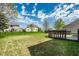 A spacious backyard with a wood deck and lush greenery, ideal for outdoor activities at 6472 Creekshore Ln, Indianapolis, IN 46268