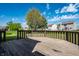 A spacious backyard includes a wood deck that is perfect for outdoor enjoyment at 6472 Creekshore Ln, Indianapolis, IN 46268
