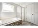 Bathroom featuring a tiled shower with glass door, soaking tub, and tile flooring at 6472 Creekshore Ln, Indianapolis, IN 46268