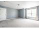 Light-filled bedroom with carpet, large closet, and a window with gray curtains at 6472 Creekshore Ln, Indianapolis, IN 46268