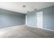 Bedroom with blue-gray walls, neutral carpet, and a door leading to the hallway at 6472 Creekshore Ln, Indianapolis, IN 46268