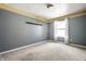 Bedroom with gray walls, carpet, and a window with white curtains at 6472 Creekshore Ln, Indianapolis, IN 46268