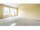 Inviting living room with carpet flooring and lots of natural light from the large window at 6472 Creekshore Ln, Indianapolis, IN 46268