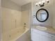 Bright bathroom featuring a jacuzzi tub, vanity with sink and a round mirror at 6628 Dunsdin Dr, Plainfield, IN 46168