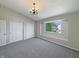 Bright bedroom featuring a window view, plush carpeting, white walls, a vaulted ceiling and closet space at 6628 Dunsdin Dr, Plainfield, IN 46168