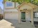 A charming home featuring a front entrance with a green door, attached garage, and well-maintained landscaping at 6628 Dunsdin Dr, Plainfield, IN 46168