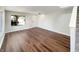 Sunlit living room boasts hardwood floors and staircase leading to the upper level; bright and inviting at 6628 Dunsdin Dr, Plainfield, IN 46168
