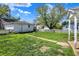 A well-kept backyard with a white fence and a detached garage is ready for outdoor activities at 704 Baronne St, Lebanon, IN 46052