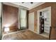 Bedroom features wood paneled walls, a window, a closet, and hardwood floors at 704 Baronne St, Lebanon, IN 46052