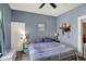 Bedroom features blue walls, a large bed, ceiling fan, and door at 704 Baronne St, Lebanon, IN 46052