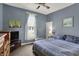 Bedroom features blue walls, a large bed, ceiling fan, and window at 704 Baronne St, Lebanon, IN 46052