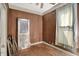 Bedroom features wood paneled walls, a window, and hardwood floors at 704 Baronne St, Lebanon, IN 46052
