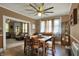 Open-concept dining area showcasing wood floors, adjacent living space, and natural light from several windows at 704 Baronne St, Lebanon, IN 46052