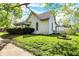 Well-maintained home exterior with mature trees and a spacious yard at 704 Baronne St, Lebanon, IN 46052