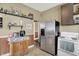 Kitchen featuring a stainless-steel refrigerator, white range, dark cabinets, and tiled floor at 704 Baronne St, Lebanon, IN 46052