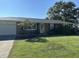 Charming brick ranch home featuring a lush front lawn and mature trees in a desirable neighborhood at 762 N Dellasburg Rd, Columbus, IN 47203