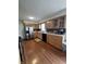 Functional kitchen with stainless steel appliances, wood cabinets, and a modern backsplash at 762 N Dellasburg Rd, Columbus, IN 47203