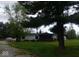 Lovely home with a covered porch and a spacious front yard at 7639 N Frontage Rd, Fairland, IN 46126