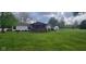 Charming home with a cozy front porch and lush green lawn at 7639 N Frontage Rd, Fairland, IN 46126