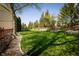 Expansive backyard features lush lawn, mature trees, fire pit, and wooded perimeter at 7926 White Pine Dr, Avon, IN 46123