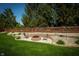 Backyard fire pit with brick surround, stone accents, and lawn at 7926 White Pine Dr, Avon, IN 46123