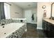 Bathroom with jacuzzi tub with decorative tile surround and vanity with double sinks at 7926 White Pine Dr, Avon, IN 46123