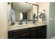 Bathroom featuring double vanity with granite countertops and dark wood cabinets at 7926 White Pine Dr, Avon, IN 46123