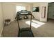 Bedroom featuring a treadmill and doorway leading to a closet with wire shelving at 7926 White Pine Dr, Avon, IN 46123