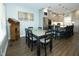 Cozy dining area with wood floors, gray cabinets, a stainless steel refrigerator, and modern light fixtures at 7926 White Pine Dr, Avon, IN 46123