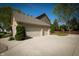 Three car garage with neutral siding and manicured landscaping at 7926 White Pine Dr, Avon, IN 46123