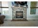 Close-up of a stone fireplace with a wood mantel and a flat-screen TV above at 7926 White Pine Dr, Avon, IN 46123