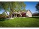 Charming two-story brick home with manicured lawn, mature trees, and inviting front porch at 7926 White Pine Dr, Avon, IN 46123