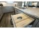 Kitchen island with granite countertop and a built-in trash can and pull out cutting board at 7926 White Pine Dr, Avon, IN 46123