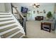 Cozy living room with fireplace, plush carpeting, and stairway to the left at 7926 White Pine Dr, Avon, IN 46123