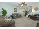 Spacious living room with comfortable seating, ceiling fan, and adjacent staircase at 7926 White Pine Dr, Avon, IN 46123