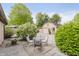 Outdoor seating area near a detached garage and mature green foliage at 807 Whitmore St, Anderson, IN 46012
