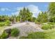 Secluded backyard with trees, a fire pit, lawn, gravel, and several seating areas at 807 Whitmore St, Anderson, IN 46012